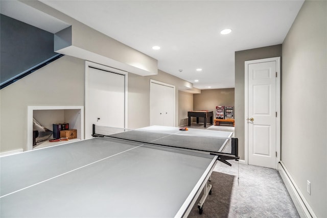 recreation room featuring recessed lighting, a baseboard heating unit, and carpet