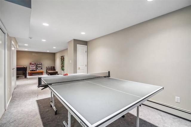 rec room with recessed lighting, a baseboard heating unit, and light carpet
