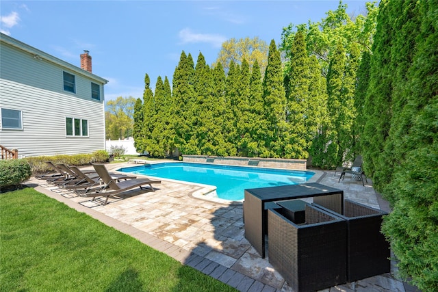 outdoor pool featuring a diving board and a patio area