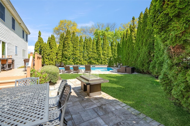 view of patio featuring an outdoor pool, a wooden deck, and outdoor dining space