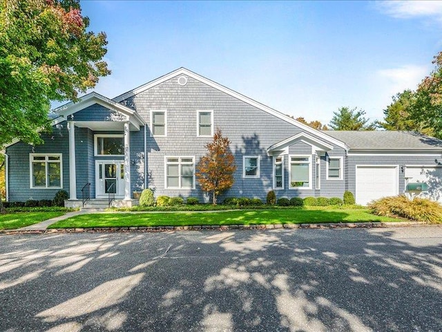 view of front of home with a front yard and an attached garage