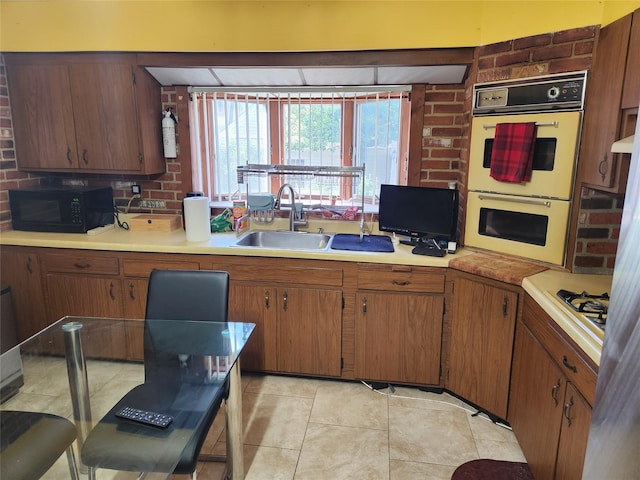 112 Rutland Rd, Hempstead, NY 11550 - kitchen featuring black microwave, a sink, double oven, and light countertops