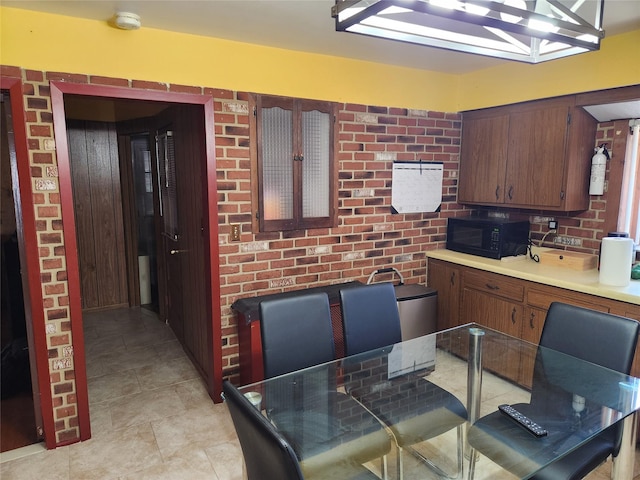 112 Rutland Rd, Hempstead, NY 11550 - kitchen with black microwave, light countertops, and light tile patterned floors