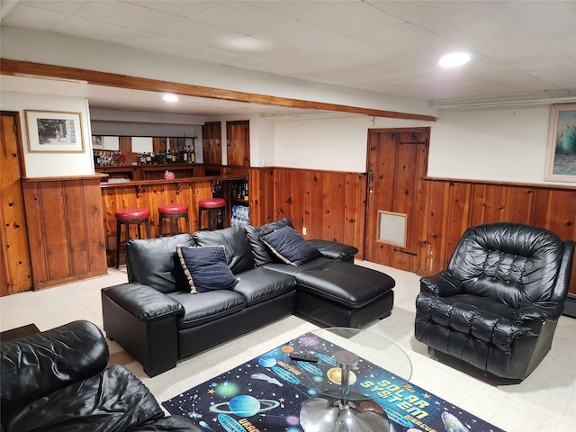 112 Rutland Rd, Hempstead, NY 11550 - living area with a wainscoted wall, wooden walls, a bar, tile patterned floors, and recessed lighting
