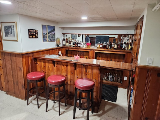 112 Rutland Rd, Hempstead, NY 11550 - indoor bar featuring wainscoting, wooden walls, and tile patterned floors