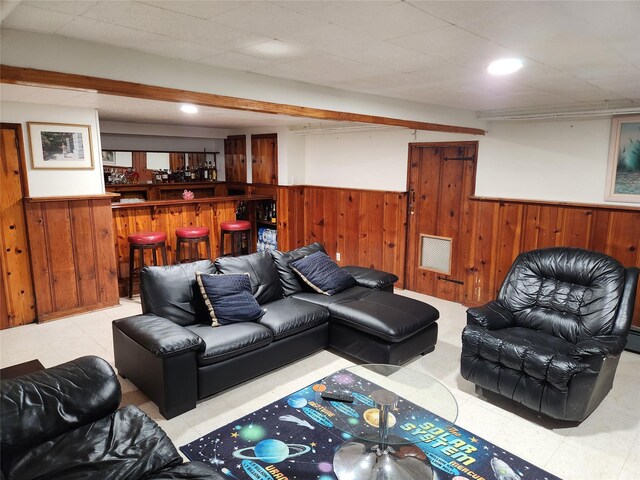 112 Rutland Rd, Hempstead, NY 11550 - living room featuring wainscoting, wooden walls, a bar, tile patterned floors, and recessed lighting