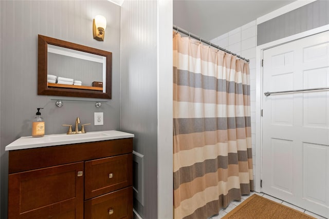 full bathroom with curtained shower, tile patterned flooring, and vanity