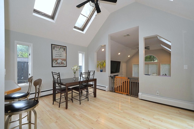 20 Richmond Blvd, Lake Grove, NY 11755 - dining area with ceiling fan, vaulted ceiling, a baseboard heating unit, a skylight, and wood finished floors