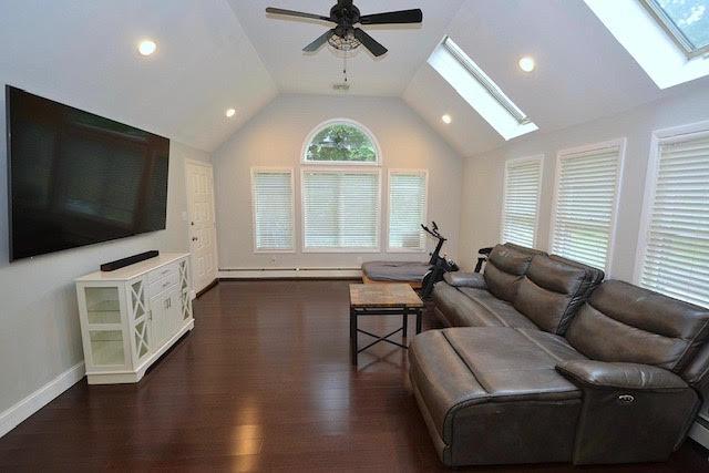 20 Richmond Blvd, Lake Grove, NY 11755 - living room with a skylight, vaulted ceiling, a ceiling fan, dark wood-style floors, and recessed lighting