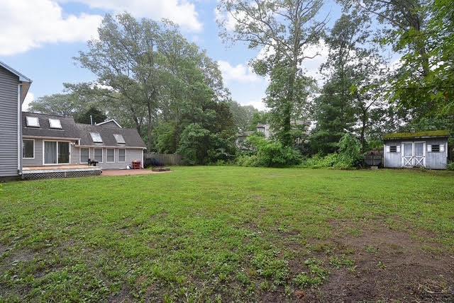 20 Richmond Blvd, Lake Grove, NY 11755 - view of grassy yard featuring a storage shed and a patio
