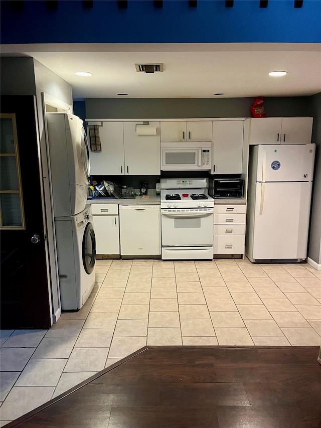20 Richmond Blvd, Lake Grove, NY 11755 - kitchen featuring white appliances, stacked washing machine and dryer, light tile patterned floors, white cabinets, and recessed lighting