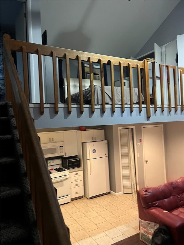 20 Richmond Blvd, Lake Grove, NY 11755 - staircase with tile patterned floors and vaulted ceiling