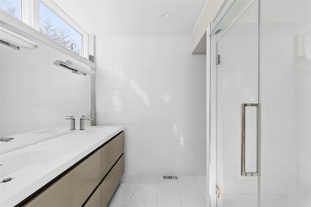 bathroom featuring tile walls, tile patterned floors, and a sink