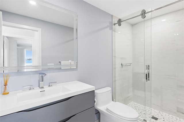 bathroom with vanity, recessed lighting, a shower stall, and toilet