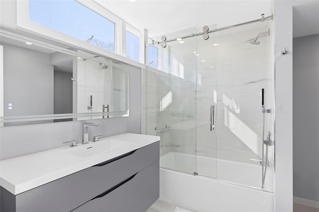 bathroom featuring vanity and shower / bath combination with glass door