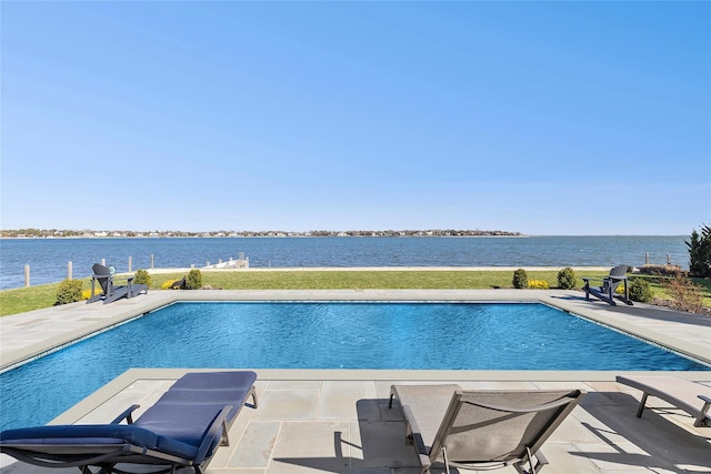 outdoor pool with a water view and a patio