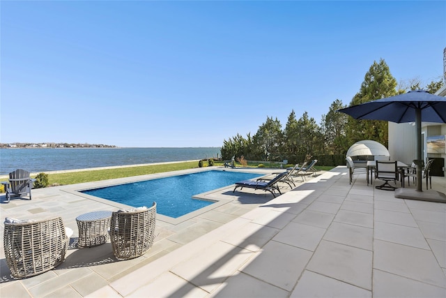pool with a patio and a water view