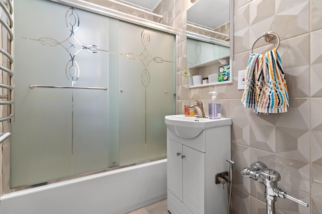 83-25 98th St Unit 3T, Woodhaven, NY 11421 - bathroom featuring vanity, combined bath / shower with glass door, and tile walls