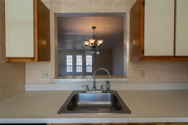 24 Timberline Trl, Pawling, NY 12564 - kitchen with hanging light fixtures, a sink, a chandelier, and light countertops