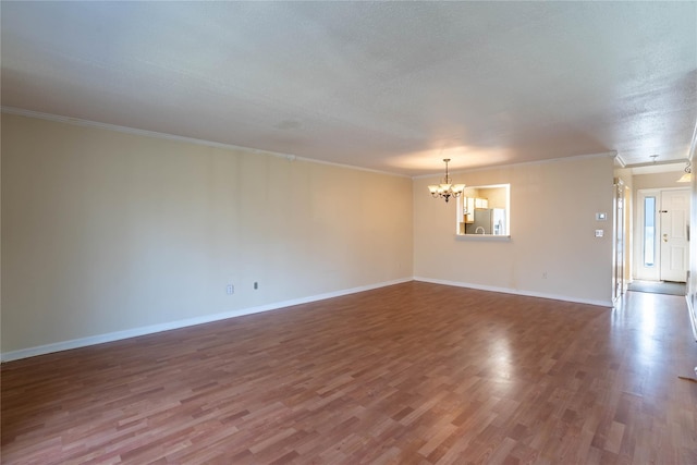 24 Timberline Trl, Pawling, NY 12564 - unfurnished room featuring wood finished floors, a chandelier, baseboards, a textured ceiling, and crown molding