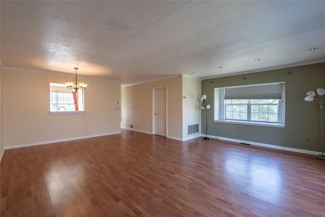 24 Timberline Trl, Pawling, NY 12564 - unfurnished living room with an inviting chandelier, visible vents, plenty of natural light, and crown molding