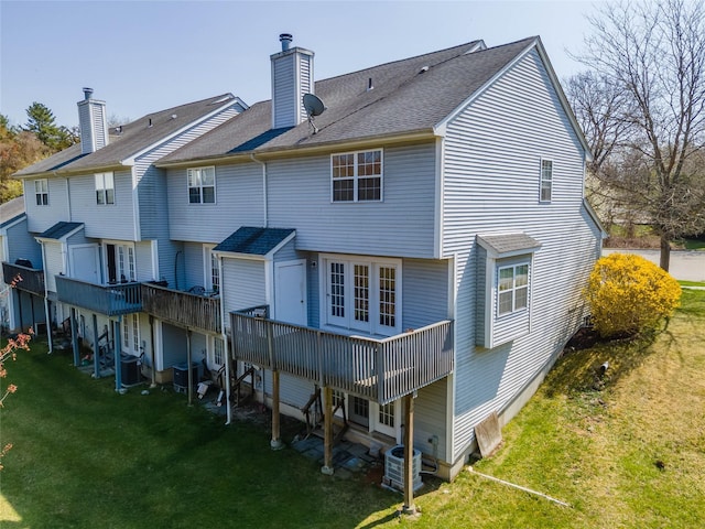 24 Timberline Trl, Pawling, NY 12564 - rear view of house featuring a chimney, a wooden deck, central AC unit, and a lawn