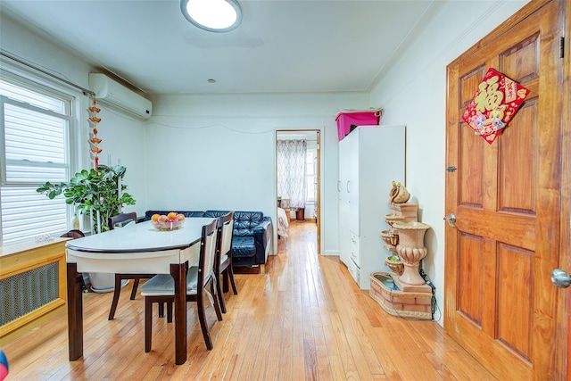 121-41 6th Ave, College Point, NY 11356 - dining area with radiator heating unit, a wall mounted AC, and light wood-style flooring