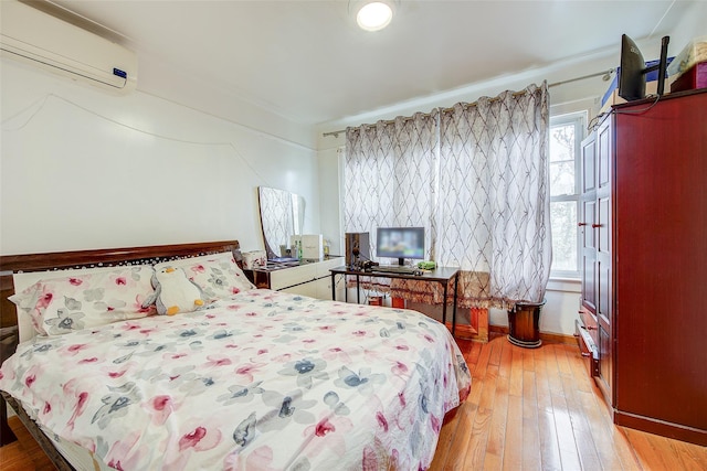 121-41 6th Ave, College Point, NY 11356 - bedroom featuring light wood-type flooring and an AC wall unit