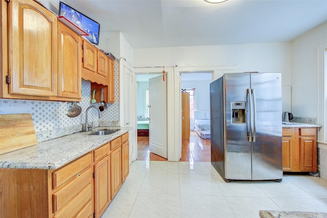121-41 6th Ave, College Point, NY 11356 - kitchen with light stone countertops, light tile patterned floors, a sink, and stainless steel fridge with ice dispenser