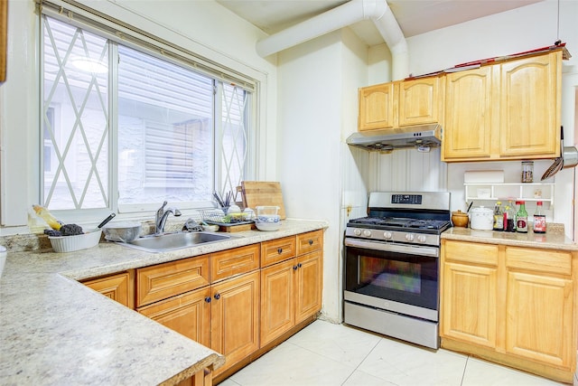 121-41 6th Ave, College Point, NY 11356 - kitchen featuring light countertops, under cabinet range hood, a sink, and stainless steel gas range oven
