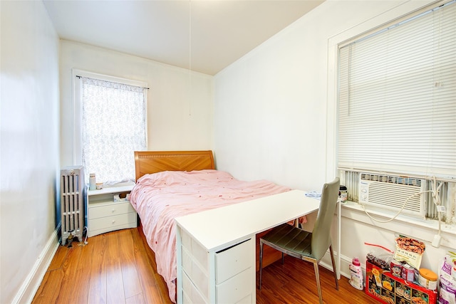 121-41 6th Ave, College Point, NY 11356 - bedroom with radiator heating unit, cooling unit, baseboards, and wood-type flooring