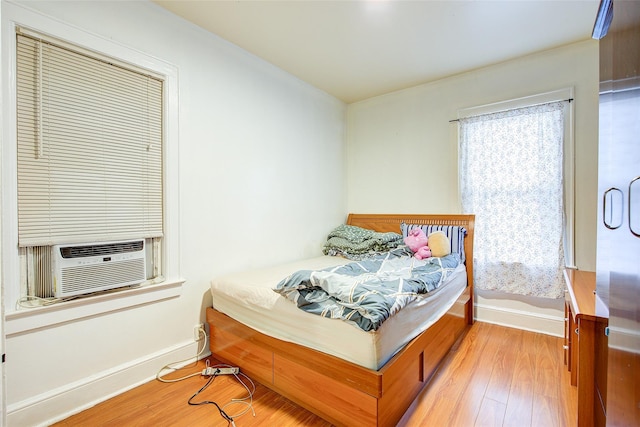 121-41 6th Ave, College Point, NY 11356 - bedroom featuring cooling unit, baseboards, and wood finished floors