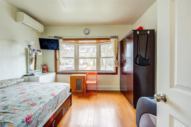 121-41 6th Ave, College Point, NY 11356 - bedroom featuring baseboards, light wood-type flooring, and a wall unit AC