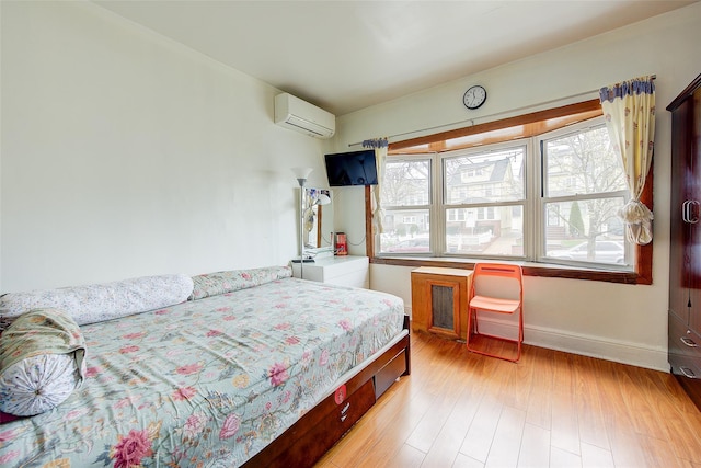 121-41 6th Ave, College Point, NY 11356 - bedroom featuring light wood-type flooring, baseboards, and a wall mounted air conditioner