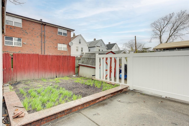121-41 6th Ave, College Point, NY 11356 - view of yard featuring a fenced backyard, an outdoor structure, a residential view, and a shed