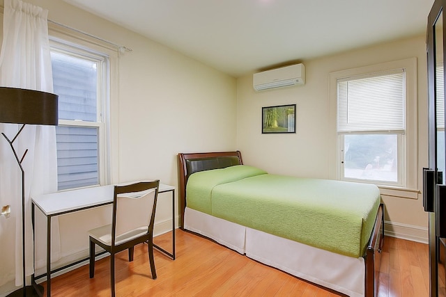 121-41 6th Ave, College Point, NY 11356 - bedroom featuring a wall unit AC and wood finished floors
