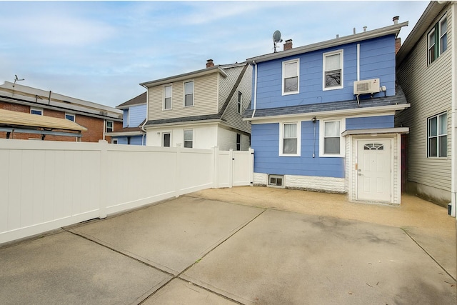 121-41 6th Ave, College Point, NY 11356 - back of house with a patio, a chimney, and a wall mounted AC