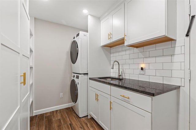 1050 Boston Post Rd, Rye, NY 10580 - washroom featuring estacked washer and dryer, cabinet space, dark wood finished floors, baseboards, and recessed lighting