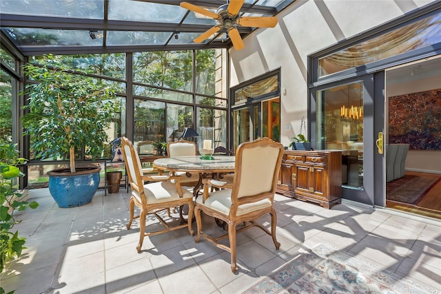 sunroom / solarium with outdoor dining area, a ceiling fan, and a wealth of natural light