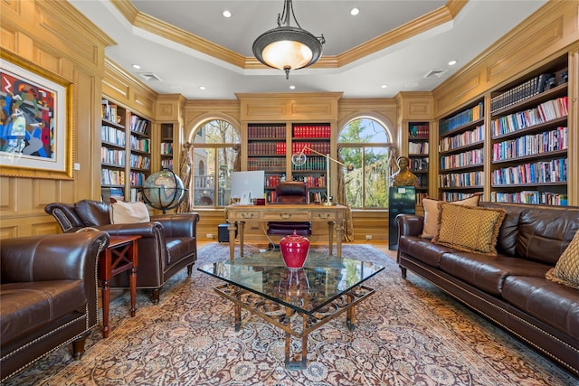 sitting room with visible vents, ornamental molding, and built in features