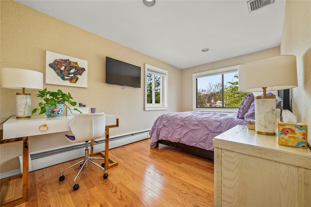 bedroom featuring visible vents, recessed lighting, light wood finished floors, and a baseboard heating unit