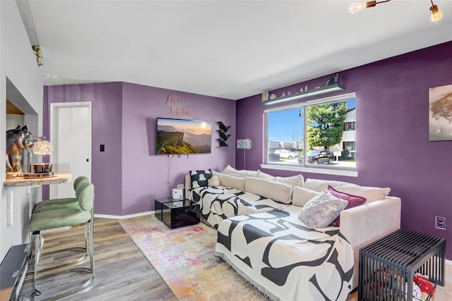 bedroom with baseboards and wood finished floors