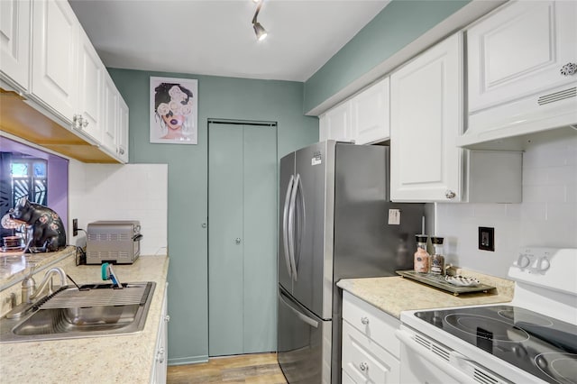 kitchen featuring white cabinets, a sink, tasteful backsplash, electric range, and light countertops
