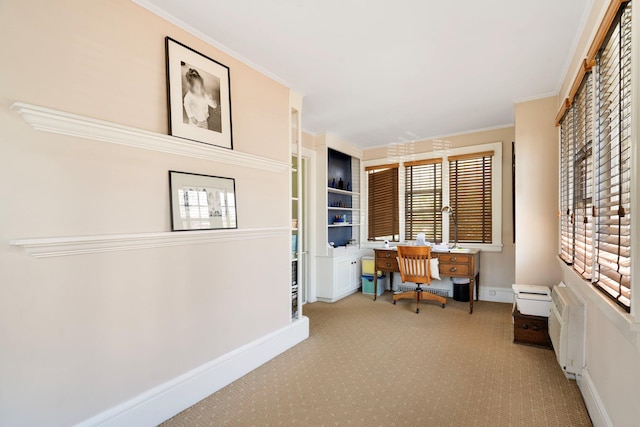 office space featuring carpet flooring, crown molding, and a healthy amount of sunlight
