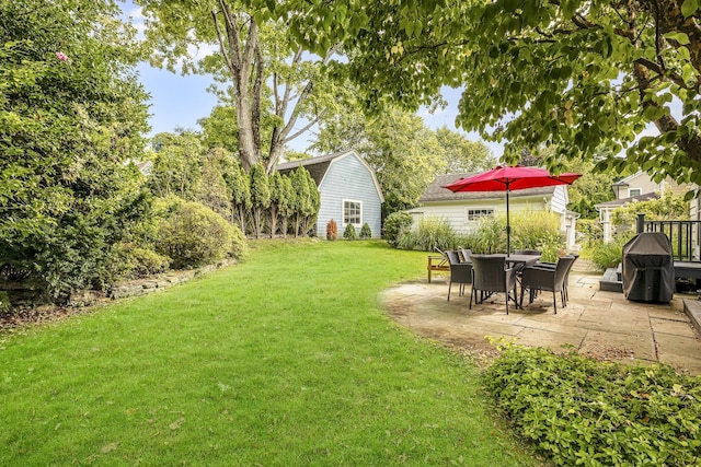 view of yard with an outbuilding and a patio area