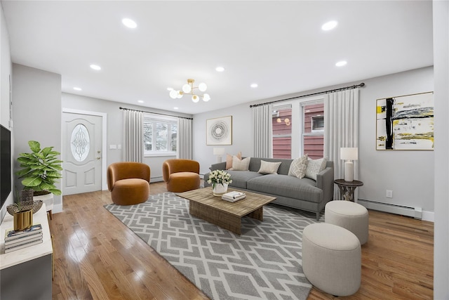 living area featuring recessed lighting, wood finished floors, and baseboard heating