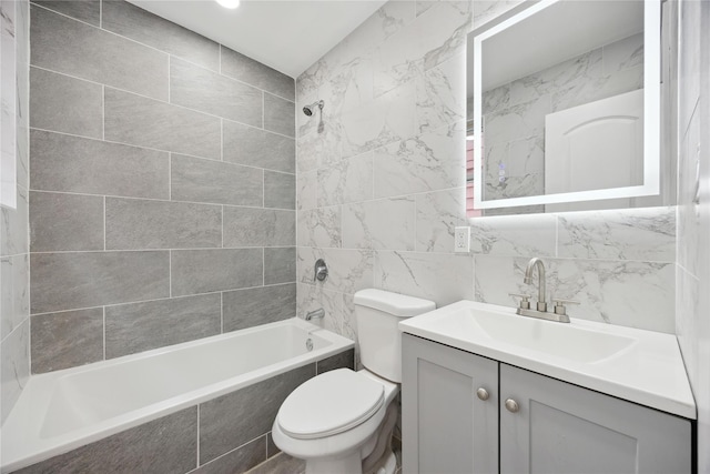 full bath with toilet, vanity, washtub / shower combination, and tile walls