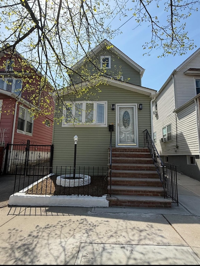 view of front of property featuring fence and entry steps