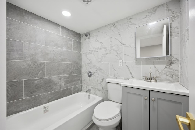 bathroom with bathing tub / shower combination, vanity, tile walls, toilet, and recessed lighting