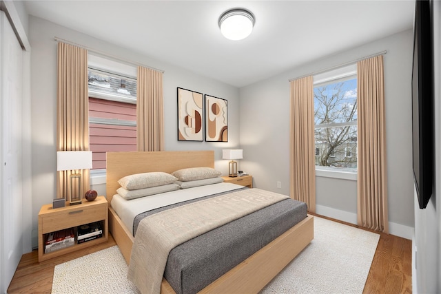 bedroom featuring wood finished floors and baseboards